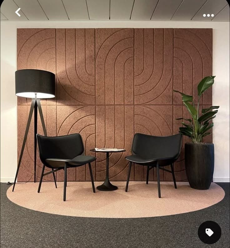 A stylish sitting area with cozy, curved chairs and soft neutral tones